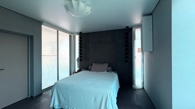 Finished bedroom with stretch walls and ceiling