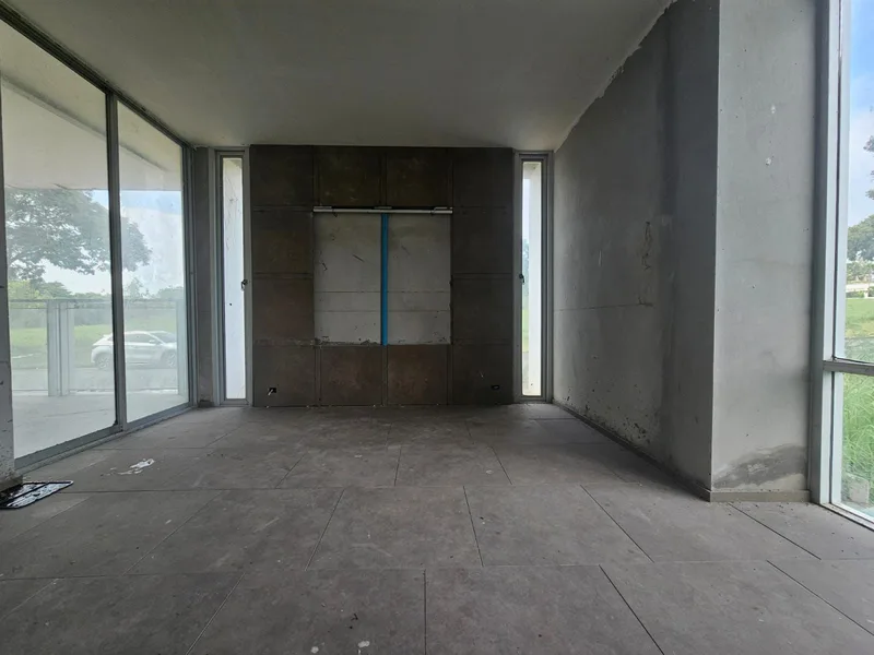 Living room with bare concrete and pipes